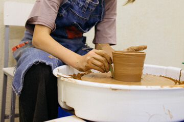 the girl is engaged in pottery