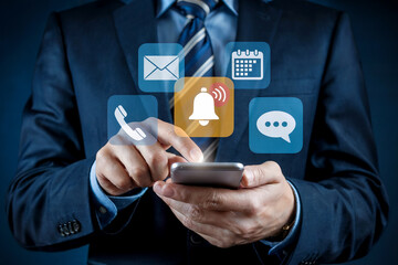 Businessman uses smartphone interacting with digital notification icons for business communication and productivity enhancement
