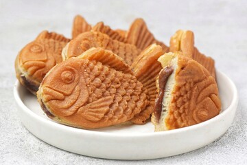 Bungeoppang Taiyaki is a popular Japanese fish-shaped cake filled with red bean jam, usually sold as a street food.