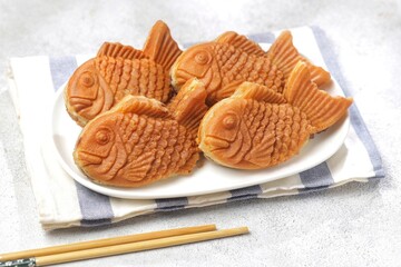 Bungeoppang Taiyaki is a popular Japanese fish-shaped cake filled with red bean jam, usually sold as a street food.