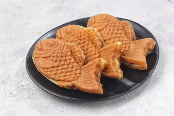 Bungeoppang Taiyaki is a popular Japanese fish-shaped cake filled with red bean jam, usually sold as a street food.