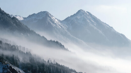 Obraz premium Mist envelops majestic snow-capped mountains, creating a serene and tranquil atmosphere perfect for nature enthusiasts.