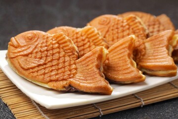 Bungeoppang Taiyaki is a popular Japanese fish-shaped cake filled with red bean jam, usually sold as a street food.