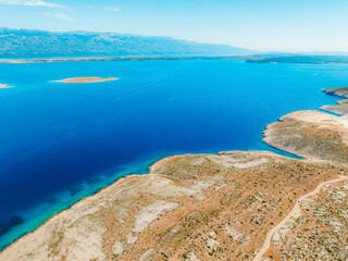 Vrsi near Zadar archipelago cove beach in stone desert scenery near Zecevo island, Dalmatia in Croatia and Pag Island in background.