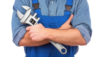 Worker in blue overall holding an adjustable wrench, isolated on white background.