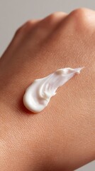 Fototapeta premium Close up of woman spreading moisturizing cream on hand, revealing smooth skincare product with hydrating and softening skin benefits