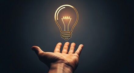 Hand holding a glowing lightbulb