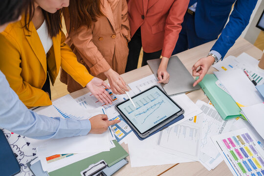 Business meeting showcases agile brainstorming with data analysis charts on tablets. Financial growth prediction strategy through predictive analytics and data-driven insights for strategic business 