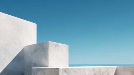 Minimalist white concrete cubes stacked symmetrically, casting shadows against blue seascape, representing architectural simplicity and geometric precision