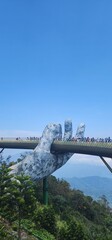 Obraz premium Golden Bridge held by giant stone hands, Ba Na Hills, Da Nang, Vietnam”