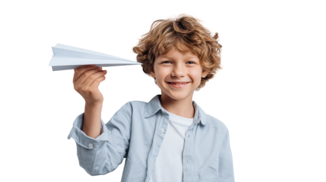Happy child holding a paper airplane, smiling against a white background.