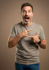 Middle-aged man in a taupe t-shirt and blue jeans. Framing a space with hands in a studio shot against a neutral backdrop. Adult male model showcasing a product, mid-studio.