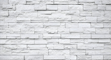 Fototapeta premium Exterior view of a light gray stone wall, featuring rectangular stone blocks arranged in a repeating pattern.