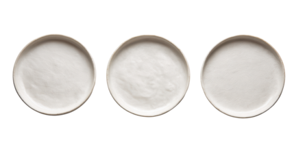 Three empty white plates arranged in a row on a black background.