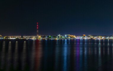 Naklejka premium The city lights reflected in the sea water. Seafront in Mangalia city seen at night