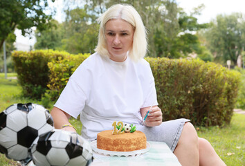 Celebration of a Special Birthday With a Soccer-Themed Cake and Playful Decor in a Vibrant Outdoor Park Setting During a Sunny Afternoon