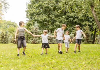 Children Enjoying a Sunny Day in the Park, Playing and Laughing Together as They Hold Hands and Run in a Joyful Circle of Friendship and Fun