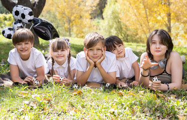 Children Enjoy a Sunny Day Outdoors Playing With Soccer Balls Among Vibrant Autumn Leaves and Cheerful Surroundings