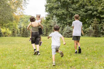 Joyful Children Run and Play Freely in a Sunlit Park on a Warm Afternoon With Family Enjoying a Day of Laughter and Adventure Together