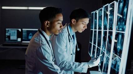 Doctors analyzing xray scans in modern medical facility with advanced imaging technology - Powered by Adobe