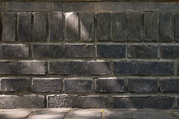 Gritty Textured Gray Brick Wall with Sunlight and Shadow Patterns