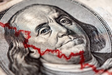 Benjamin Franklin face displayed prominently on a USD dollar banknote with a red line graph indicating a decline in value shown across the face