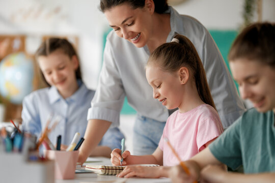 Happy kids and teacher at school