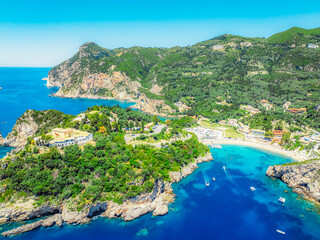 Fototapeta premium Agios Spiridon Beach with crystal azure water and beach with scenery of coastline of Corfu island near Monastery of Paleokastritsa, Ionian sea in Greece