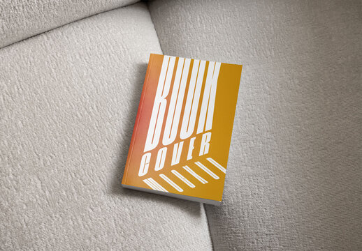 Mockup Of Customized Closed Paperback Book On Couch
