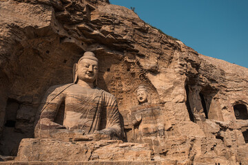 Ancient Yungang Grottoes showcase large Buddha sculptures in tranquil setting