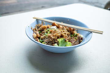 A different version of the famous phad thai but with flat noodles and chicken slices at Bangkok