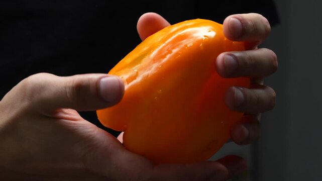Fresh and tasty parika in the hands of the cook close-up.
The cook holds ripe and aromatic paprika in his hands