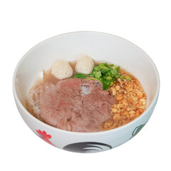 Savory Noodle Bowl: A vibrant close-up showcases a delicious bowl of noodles, featuring tender meat, fresh green herbs, savory meatballs, and a garnish of crunchy peanuts.