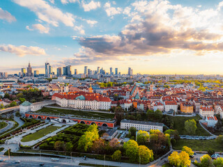 Fototapeta premium Warsaw old city center and skyscrapers in the background Vistula river. Sunset in Warsaw city center aerial view.