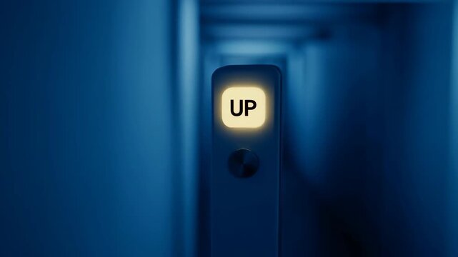 Up button illuminating in a dark hallway