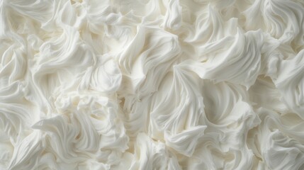 A close-up view of a white, fluffy substance resembling whipped cream or frosting.