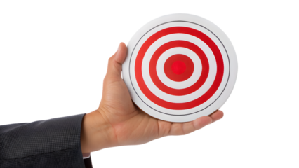 A business hand holding a red center of a target on a dartboard, symbolizing an aim for success and achievement