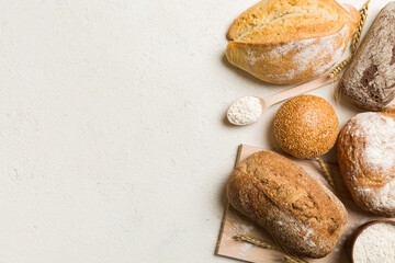 Homemade natural breads. Different kinds of fresh bread as background, top view with copy space