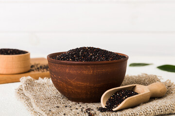 quinoa seeds in bowl and spoon on colored background. Healthy kinwa in small bowl. Healthy superfood