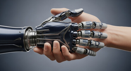 A robotic hand shaking hands with a human hand against a plain gray colored background