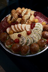 Gourmet Platter with Savory Delicacies and Fresh Fruits