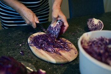 Freshly Shredded Purple Cabbage on Rustic Wood Cutting Board