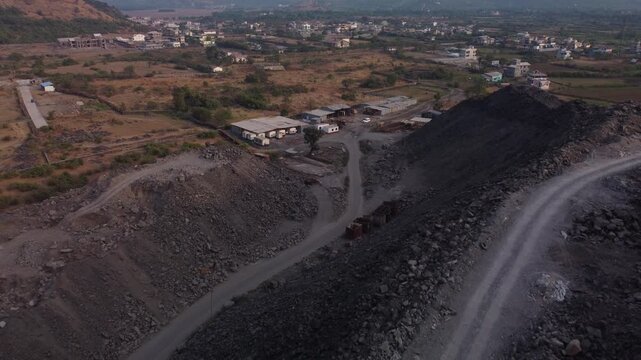 Closeup of excavated rock heap, The Mumbai Pune Expressway missing link project construction site, Western ghats, Lonavala, Maharashtra, Drone