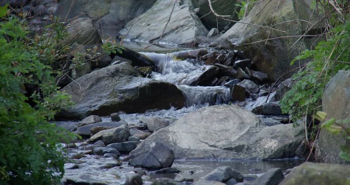 Close up shot of a small rocky stream brook at new quay beach