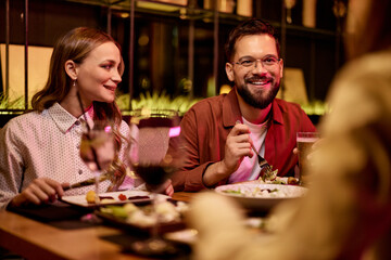Friends Dining Together at an Elegant Restaurant During a Relaxed Evening