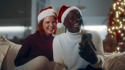 Online video call in Christmas, black man and Caucasian girlfriend celebrating. Happy diverse people spending Xmas eve at home, congratulating family and friends remotely, heart is symbol of love - Powered by Adobe