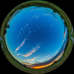 Fisheye landscape sunrise over meadow. All sky in HDR photo taken through circular lens 180 degree view
