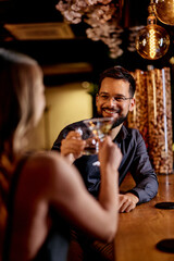 Two Friends Enjoying Drinks Together at a Cozy Bar Setting