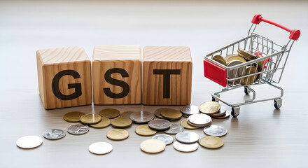 Gst concept with wooden blocks, coins and shopping cart, depicting goods and services tax, an indirect tax used in india on the supply of goods and services