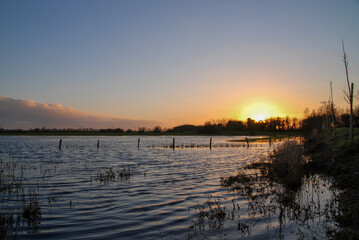Body of water with a sunset in the background